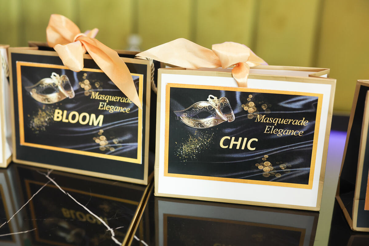 Masquerade-themed prize boxes styled on a table at a Singapore dinner and dance