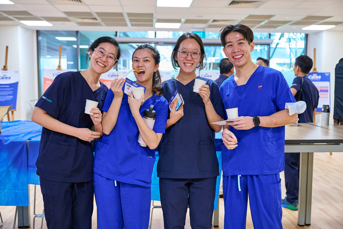 Healthcare staff posing together at a branded roadshow activation in Singapore