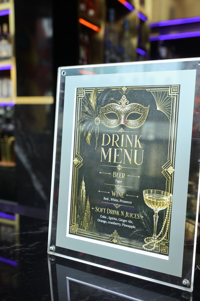 Custom masquerade drink menu signage photographed at a Singapore event