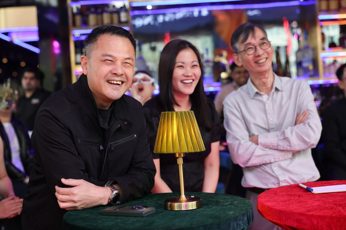 Guests laughing together at a table during a Singapore dinner and dance