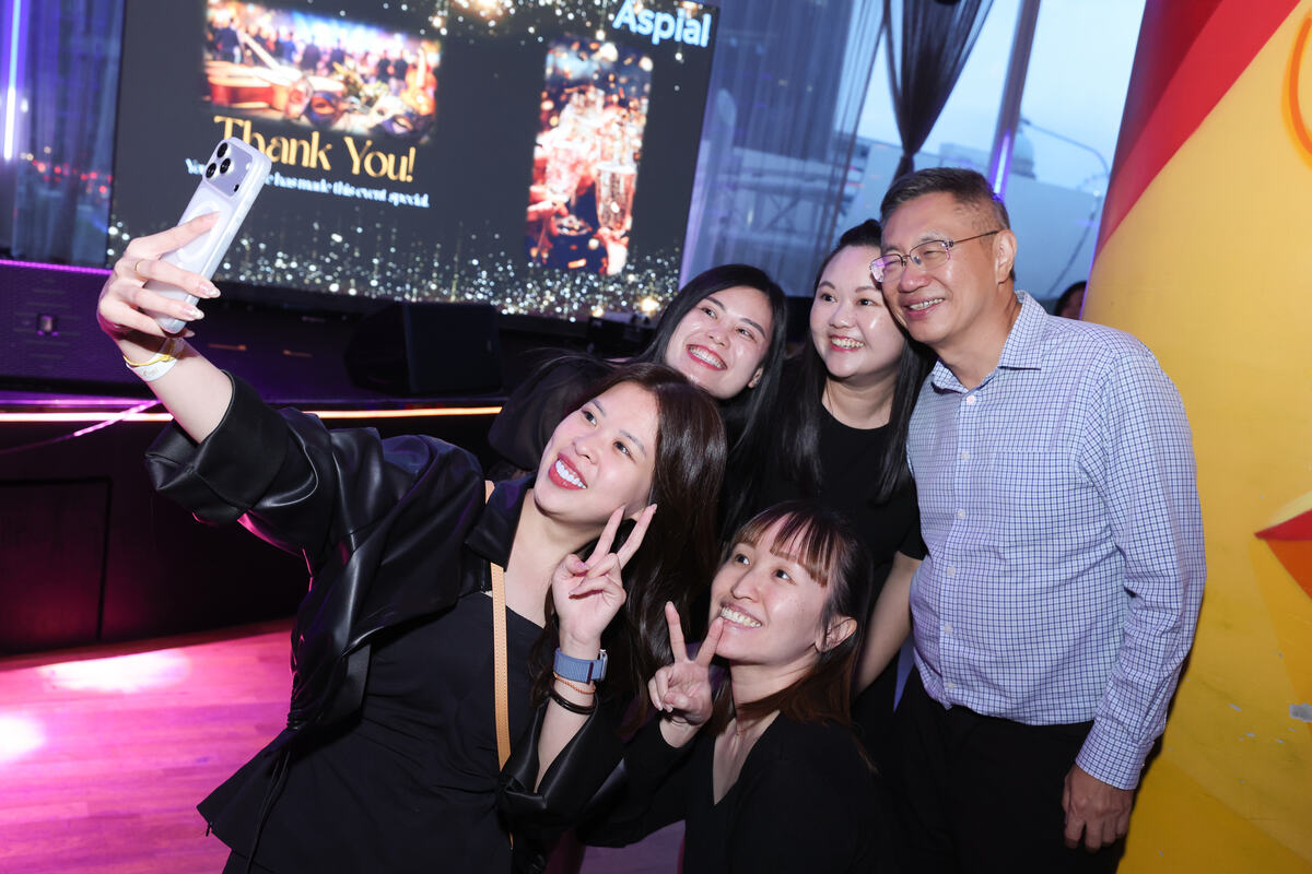 Guests taking a group photo at a Singapore corporate event