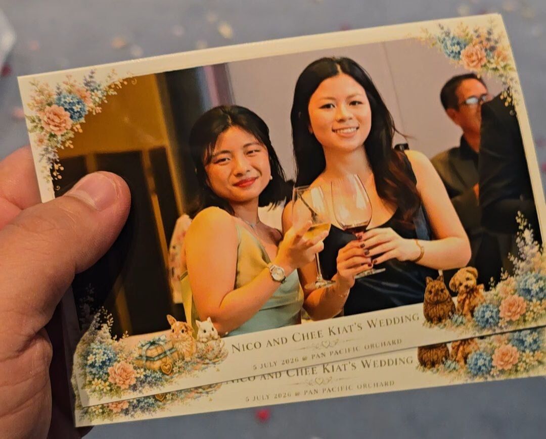 Freshly printed 4R photos being handed to guests at a wedding at Pan Pacific Orchard, Singapore